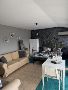 a living room with a couch and a bed at TOP SKY VIEW - Studio Panorama in Veliko Tŭrnovo