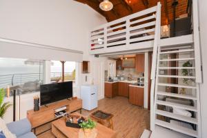a living room and kitchen with a loft bed at Aegean Balcony Apartment in Nea Peramos