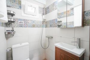 a bathroom with a shower and a sink and a toilet at Aegean Balcony Apartment in Nea Peramos +52 photos