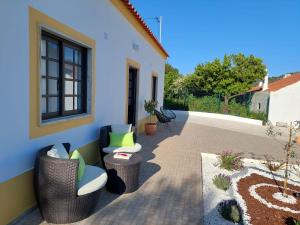 a patio with two wicker chairs and a table at Casa Oliveira in Silves