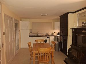 a kitchen with a table and chairs and a stove at Gweedore Seaview Cottage in Bun na Leaca +21 photos