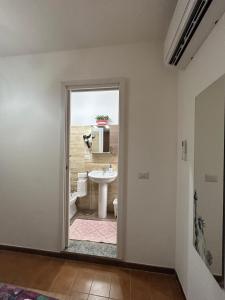 a bathroom with a sink and a toilet at La Perla del Dolcedorme in San Lorenzo Bellizzi +23 photos