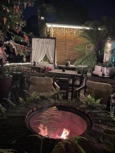 a fire pit in the middle of a patio at night at Chales Spa Exclusive - Localizado Proximo do Centro in Canela