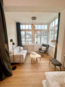 a living room with a couch and a table at DÜNENHAUS Sellin in Ostseebad Sellin