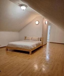 a large bedroom with a bed in an attic at Nordic DeLight in Skelleftehamn