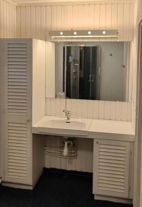 a bathroom with a sink and a mirror at Nordic DeLight in Skelleftehamn +22 photos