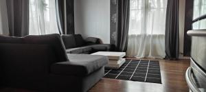 a living room with a couch and a chair at Nordic DeLight in Skelleftehamn