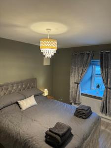 a bedroom with a bed with two towels on it at Shrule Cosy Nest in Shruthair
