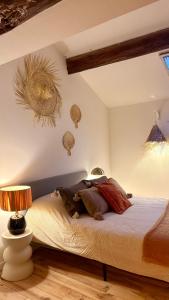a bedroom with a bed with two lamps on it at Mon nid sous les toits in L'Isle-sur-la-Sorgue