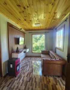 a living room with a couch and a window at Cabaña la nonita, queule in Queule