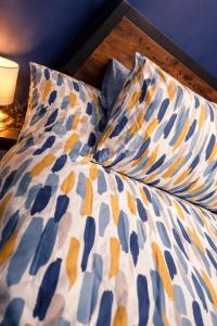 a bed with two pillows on top of it at Alpaca Hideaway in Llanstadwell