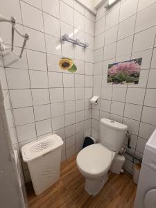 a white bathroom with a toilet and a sink at Villa Lumineuse in Le Lamentin +11 photos