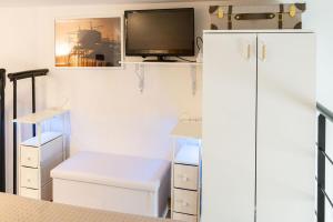 a kitchen with a tv and a white refrigerator at Sto bene al mare in Termoli