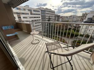 a balcony with a chair and a table at appartement vincennes avec balcon in Vincennes