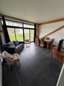 a living room with a couch and a table at Saint Pierre Gîte in Ambleteuse