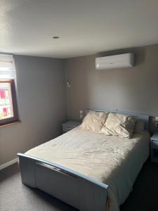 a bedroom with a large bed with a white comforter at Appart familial in Kogenheim