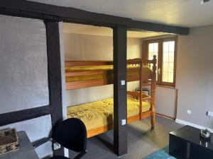 a bedroom with two bunk beds in a room at Appart familial in Kogenheim