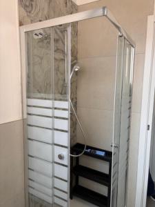 a shower with a glass door in a bathroom at sweet rest in Castel Maggiore