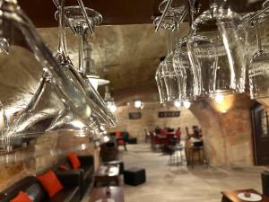 a restaurant with wine glasses hanging from the ceiling at eXo Hotel Franka Bamberg - by NeVo Hotels in Hallstadt
