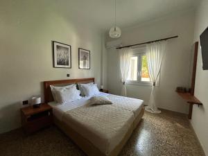 a bedroom with a bed and a window at MG elounda apt in Elounda