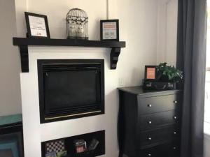 a living room with a fireplace with a tv at King Bed Condo at Cedar Breaks Lodge in Brian Head