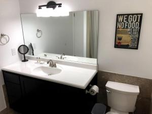 a bathroom with a sink and a mirror and a toilet at King Bed Condo at Cedar Breaks Lodge in Brian Head