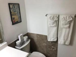 a bathroom with a white toilet and towels at King Bed Condo at Cedar Breaks Lodge in Brian Head