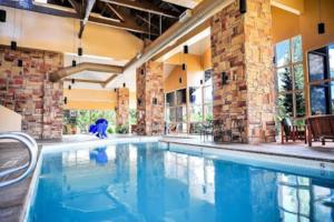a large swimming pool in a large building at King Bed Condo at Cedar Breaks Lodge in Brian Head +25 photos