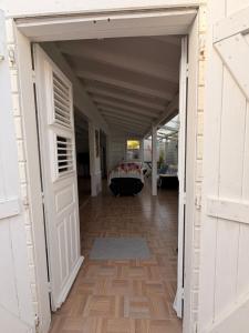 an open door leading into a hallway with a table at Villa Lumineuse in Le Lamentin