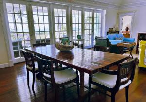 a dining room with a wooden table and chairs at The Blue Inn Family Vacation Rental in Smith Point