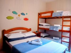 a bedroom with two bunk beds and a ladder at Rancho Magic in Cabo Frio