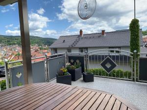a balcony of a house with potted plants on it at Seppel's Häuschen in Bad Orb