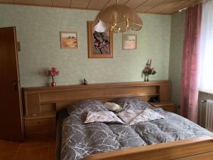 a bedroom with a bed with a wooden head board at Seppel's Häuschen in Bad Orb