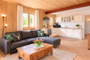 a living room with a couch and a coffee table at ChiemseeRefugium - Ferienwohnung Berg in Bernau am Chiemsee