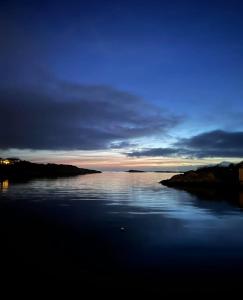 a view of a large body of water at dusk at OceanView Karmoy Jacuzzi, Sauna & Sea Views in Karmøy
