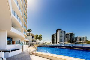 a large swimming pool in front of a large building at The Sebel Maroochydore in Maroochydore