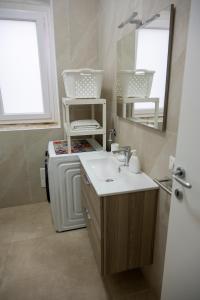 a bathroom with a sink and a mirror at Kalsa’s House Noto in Noto +20 photos