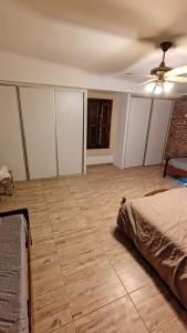 a bedroom with a ceiling fan and a tile floor at margarita in Sauce Viejo