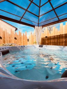 a hot tub with a roof with a city in the background at CALME - 15 min Toulouse - PISCINE - SPA in Mons