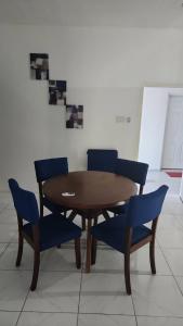 a wooden table and blue chairs in a room at Holiday festivity in St Mary