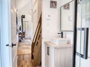 a bathroom with a sink and a mirror at Maison Eadda in Adstock +11 photos