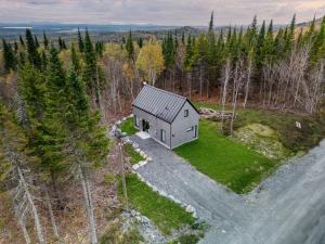 an aerial view of a small house in the woods at Maison Eadda in Adstock