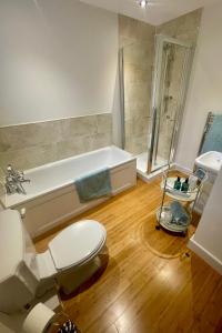 a bathroom with a toilet and a bath tub at Braemore Walled Garden in Garve