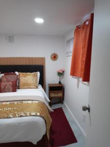 a bedroom with a large bed and a red blanket at "Cozy Basement Retreat Just 40 Minutes to NYC!" in Irvington