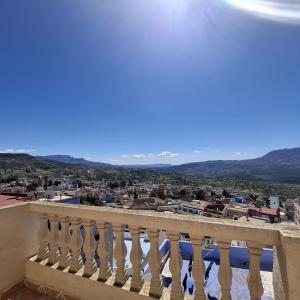 a balcony with a view of a city at Mina House in Chefchaouen