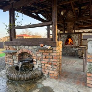 an outdoor brick oven with a fire in it at Villa Khodasheni in Kʼvemo Khodasheni