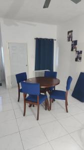 a wooden table and blue chairs in a room at Holiday festivity in St Mary