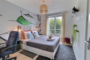 a bedroom with a bed and a chair and a window at Urban Escape - Piscine & Terrasse intime à 3 min du Parc des Coquibus - Proche ORLY in Courcouronnes +19 photos
