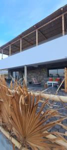 a large wooden sculpture of a sun in front of a building at Kasa surf in Porto Novo