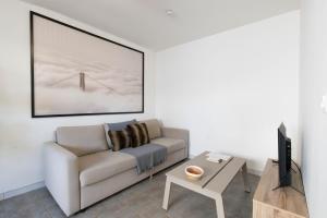 a living room with a couch and a table at T2 cocooning proche Paris et Disney in Lagny